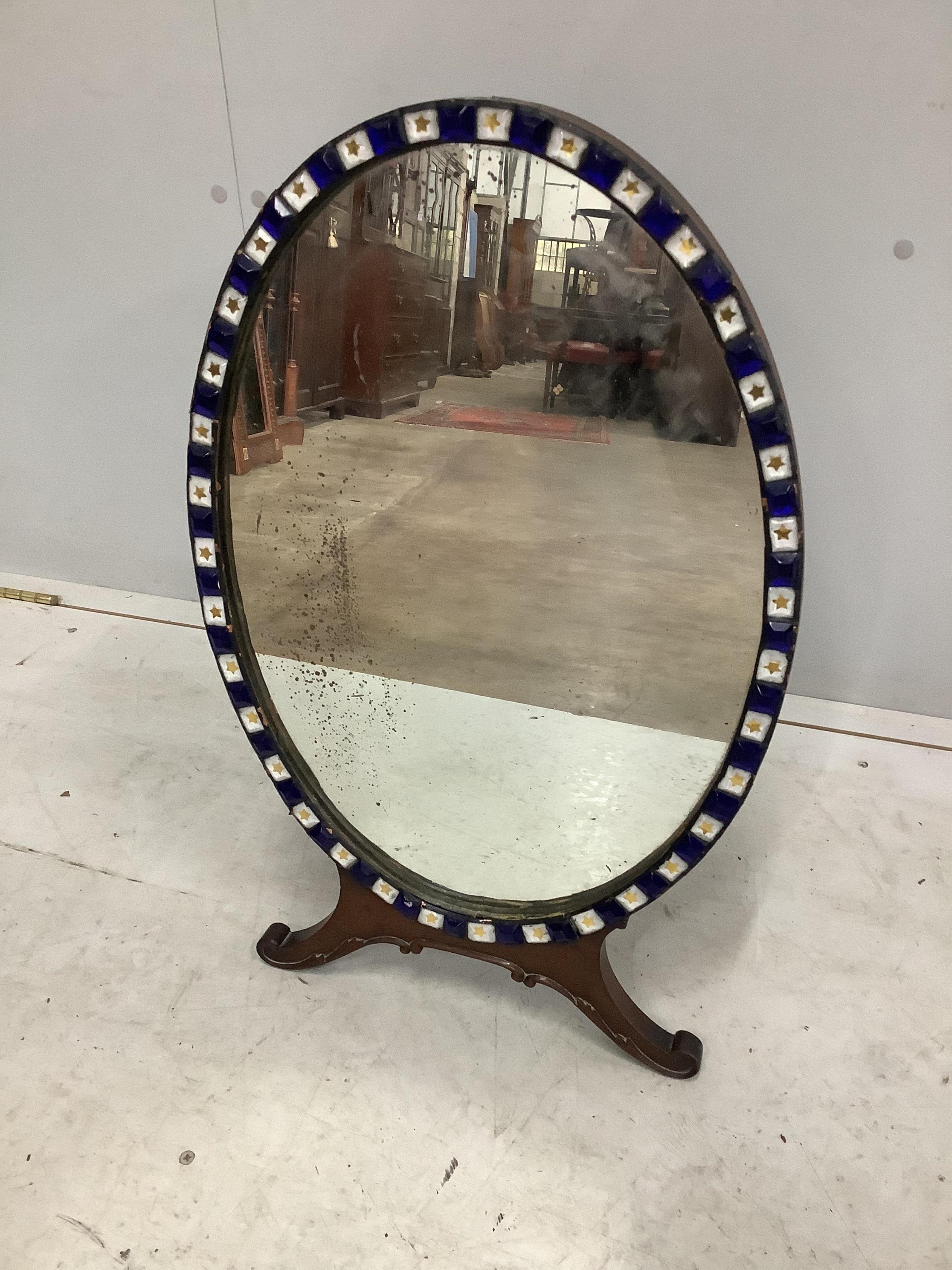 An early 20th century Irish glass bead applied mahogany toilet mirror, modelled in the 18th century manner and with label for M Butler of Dublin, width 40cm, height 62cm. Condition - fair